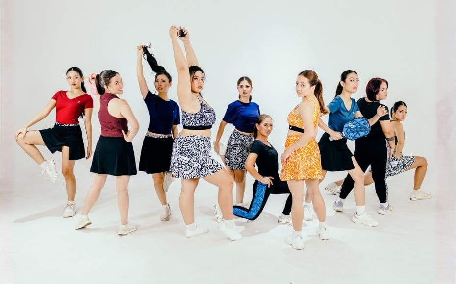 Friends wearing bright, art-inspired activewear outdoors